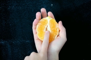 Woman hands touching a pealed orange
