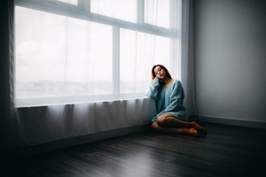 Woman sit in front of a window