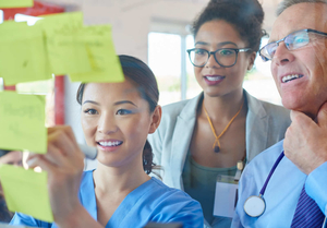 Woman doctor writing on post-it